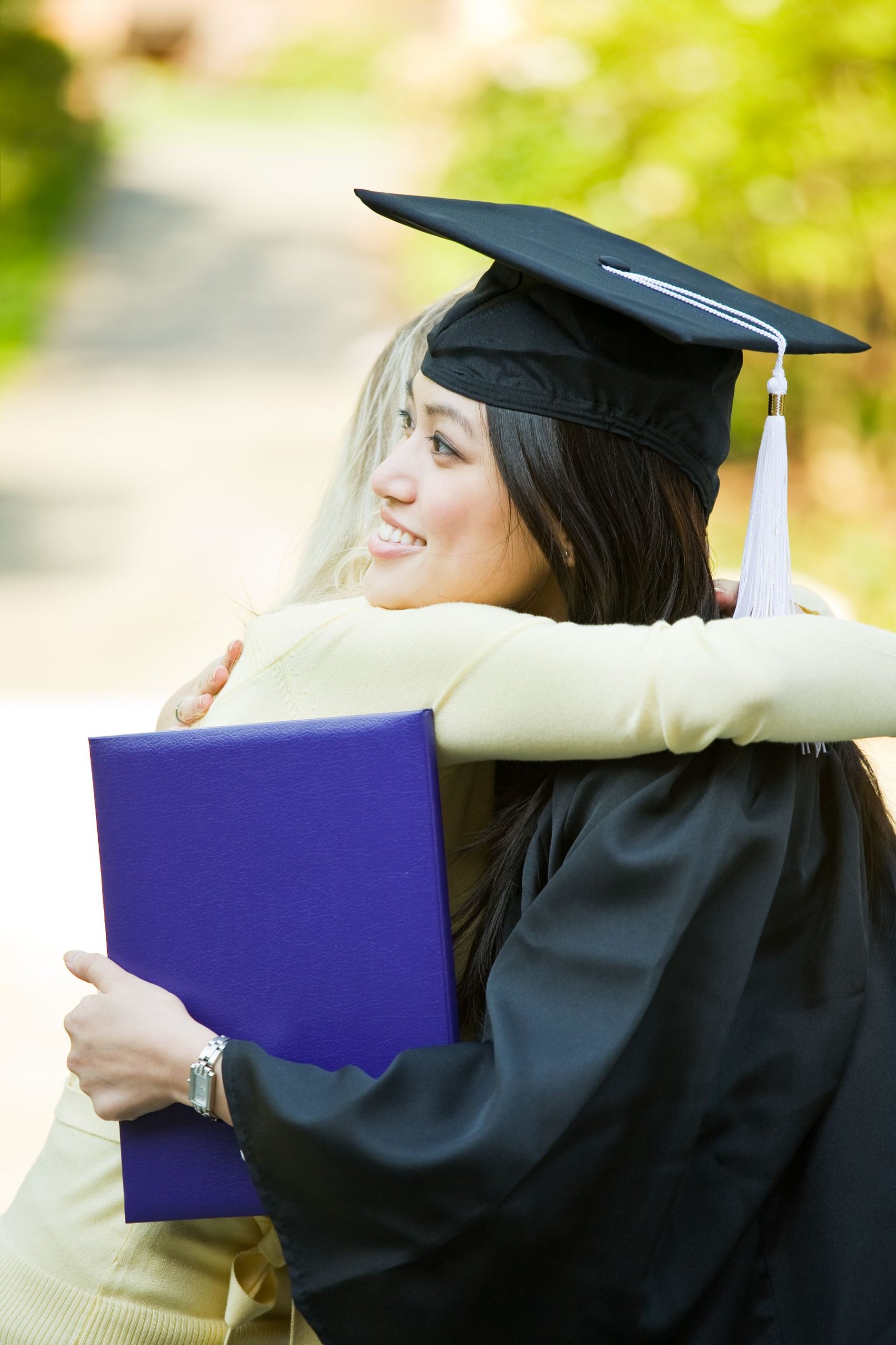 A young graduate hugging her mother