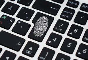User identity authenticaion symbolized by fingerprint on keyboard.
