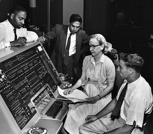 Grace Hopper with colleagues at the UNIVAC keyboard in 1960.